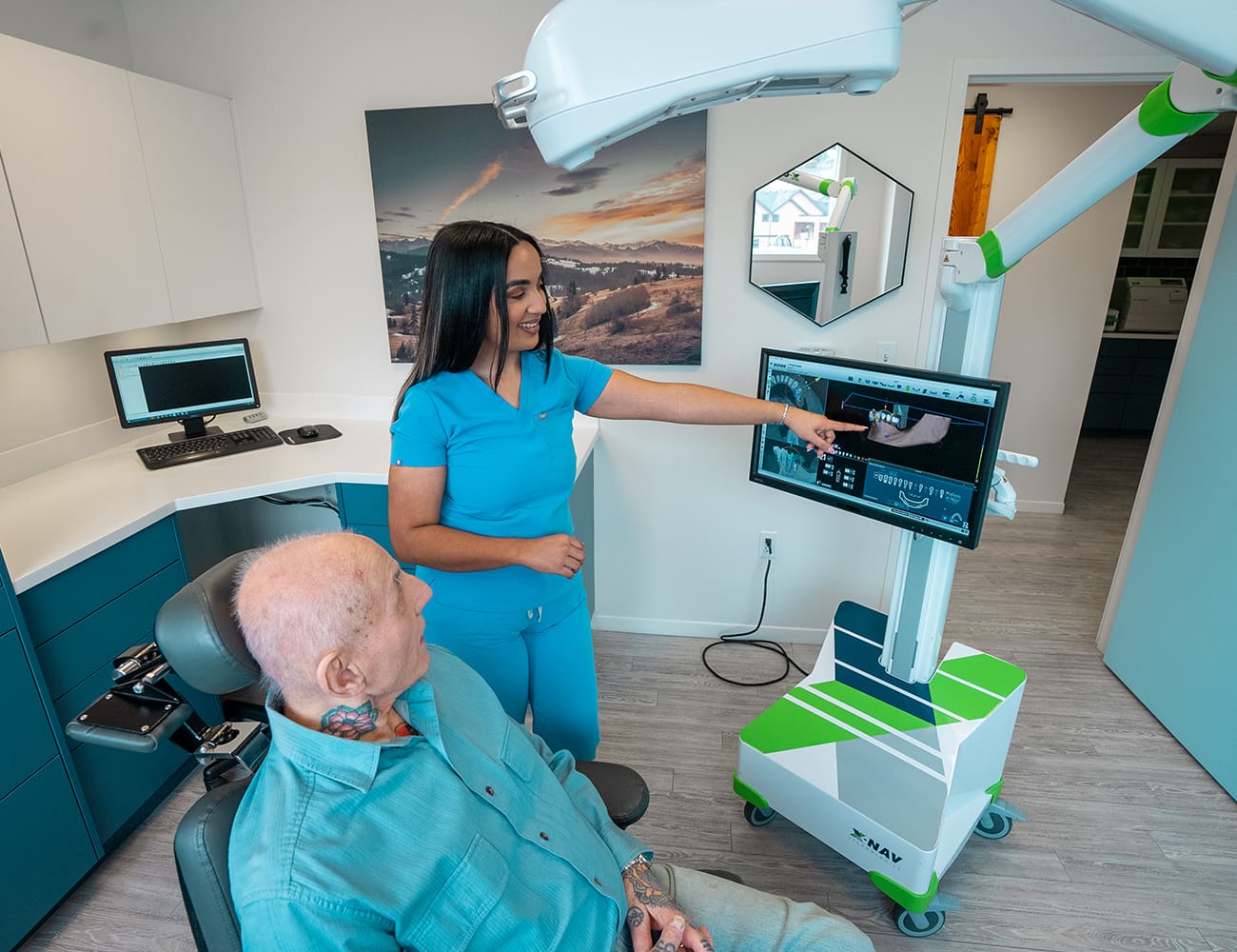 A staff member showing 3D scan of a patients teeth